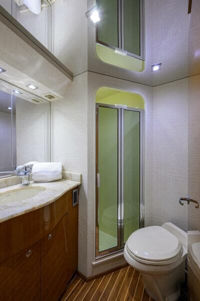2004 Viking 65 Enclosed Bridge yacht bathroom with shower, sink, and toilet.