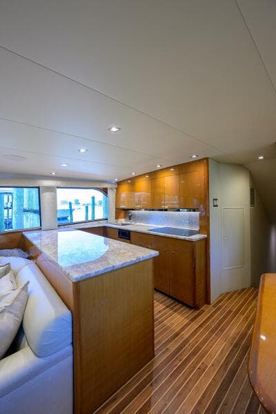 Luxurious interior of 2004 Viking 65 Enclosed Bridge yacht with modern kitchen and seating area.