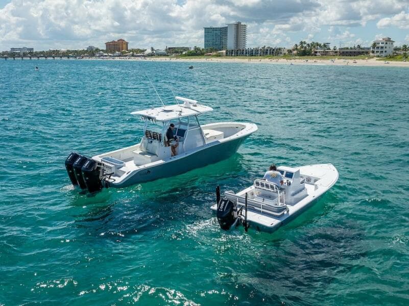 2025 Billfish 39 Center Console with Tower on ocean near beach.