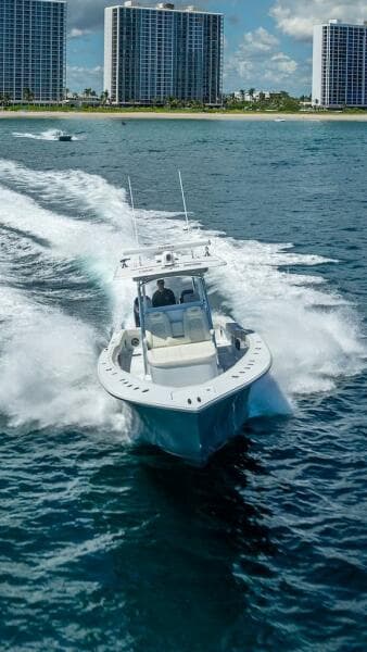 2025 Billfish 39 Center Console boat cruising near skyscrapers on a sunny day.