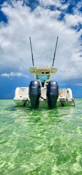 2021 Sailfish 272 CC boat in clear turquoise water under a blue sky.