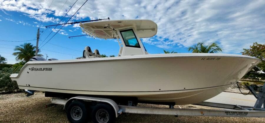 2021 Sailfish 272 CC boat on trailer under blue sky.