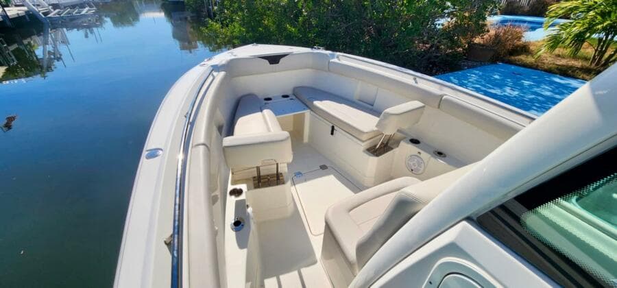 2021 Sailfish 272 CC boat interior with seating, docked by calm water.