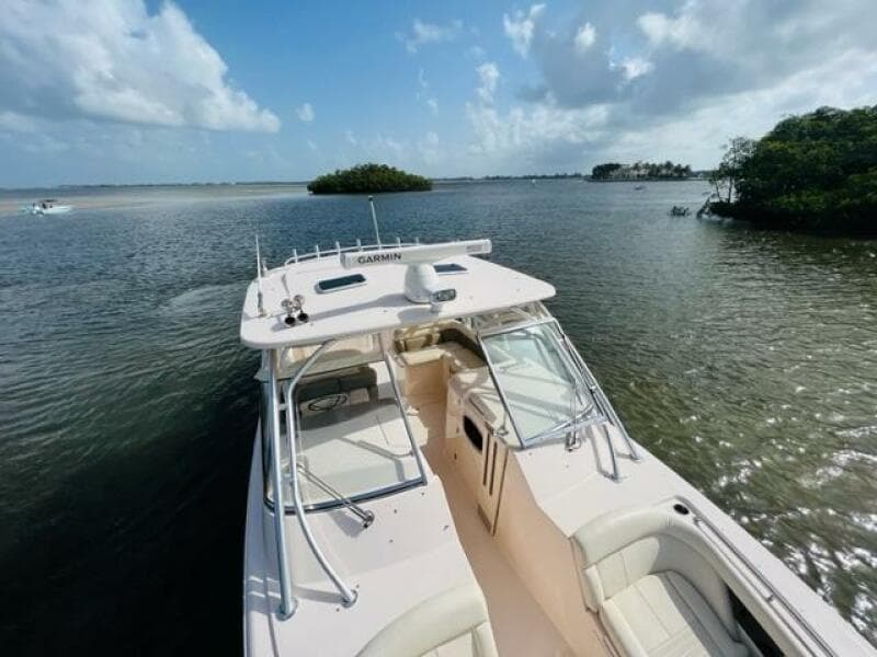 2014 Grady-White Freedom 335 boat on calm waters with scenic island background.