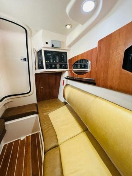 2014 Grady-White Freedom 335 cabin interior with control panels and yellow seating.