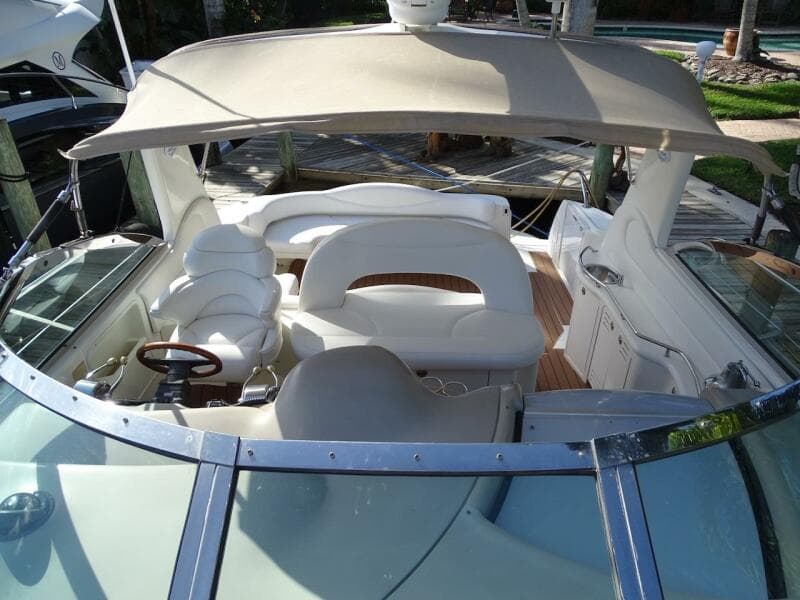 2001 Sea Ray 410 Sundancer boat interior with white seating and canopy.