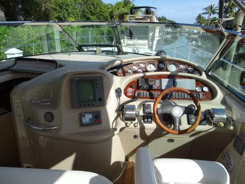 Helm of 2001 Sea Ray 410 Sundancer yacht with navigation equipment and steering wheel.