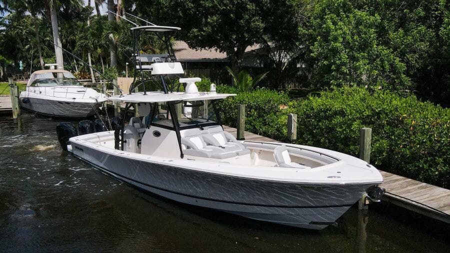 2020 Regulator 41 boat docked in a marina with lush greenery.