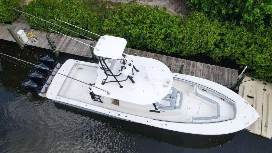 Aerial view of a 2020 Regulator 41 boat docked by a wooden pier.