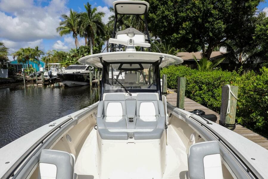 2020 Regulator 41 boat docked in a scenic marina with lush greenery.