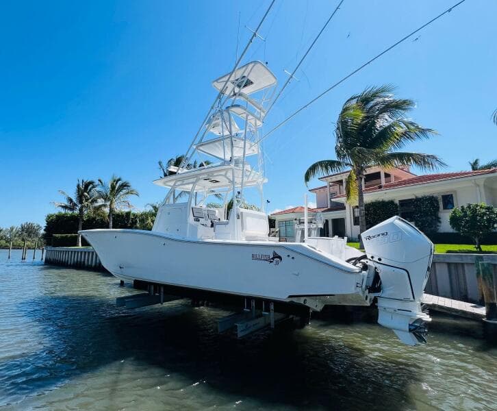 2015 Billfish 39 Custom CC boat docked near waterfront property.