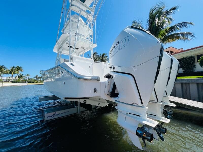 2015 Billfish 39 Custom CC boat with twin outboard engines docked by the water.