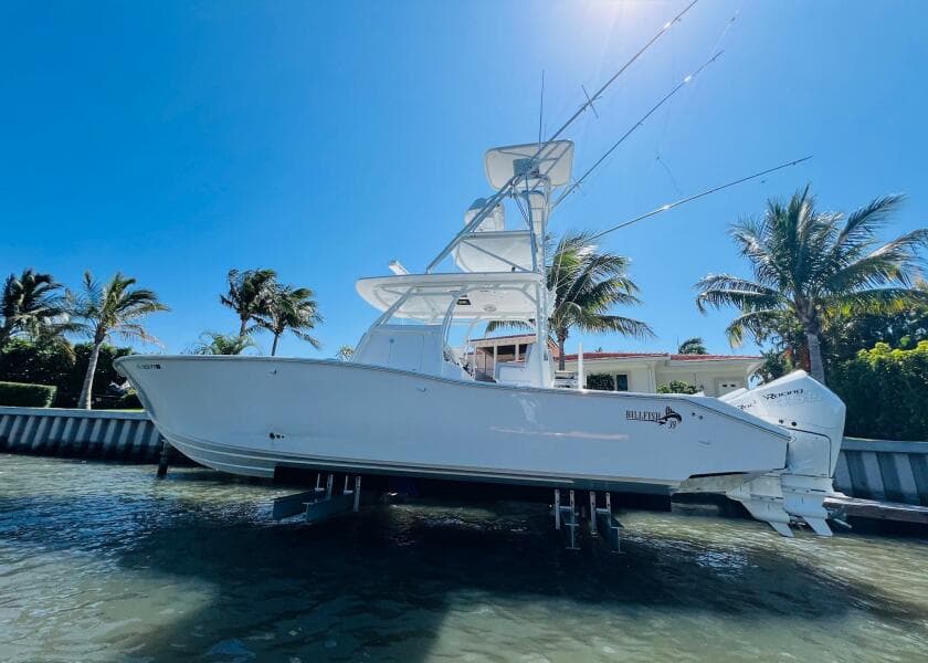 2015 Billfish 39 Custom CC boat docked near palm trees.