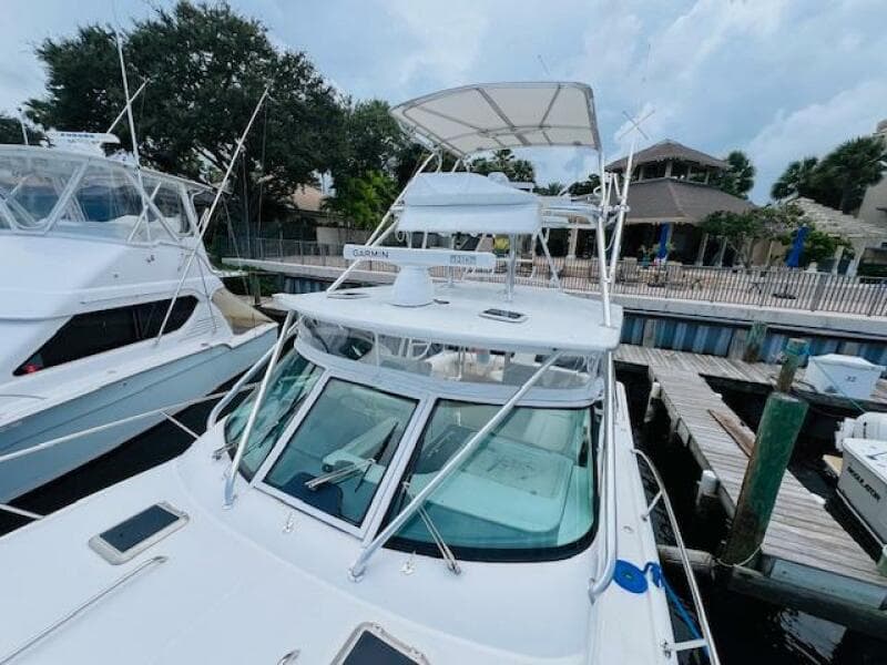 2003 Tiara Yachts 3800 Open docked at marina, featuring sleek design and spacious deck.