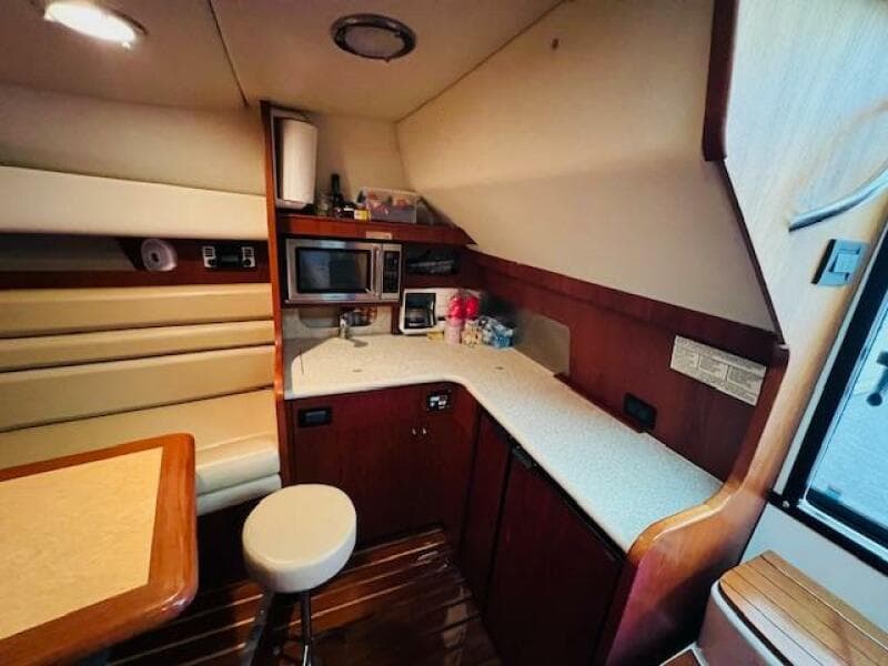 2003 Tiara Yachts 3800 Open interior with kitchenette and seating area.