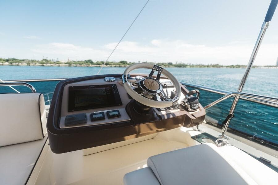 Steering console of 2015 Beneteau Monte Carlo 5 yacht with ocean view.