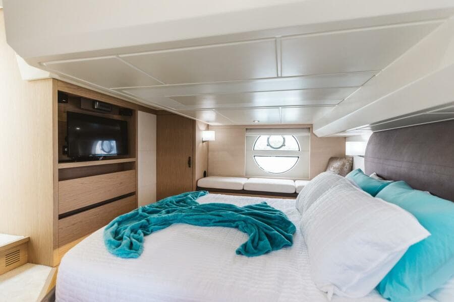 Luxurious bedroom in 2015 Beneteau Monte Carlo 5 yacht with modern decor.