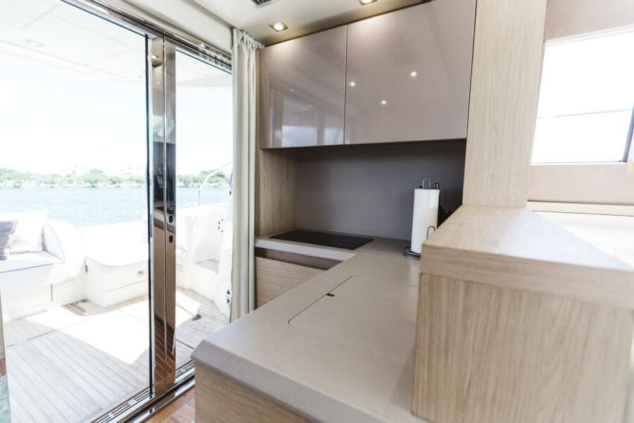 Interior of 2015 Beneteau Monte Carlo 5 yacht with modern kitchen and outdoor view.