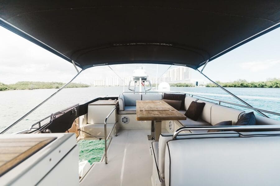2015 Beneteau Monte Carlo 5 yacht interior with seating and table on deck.