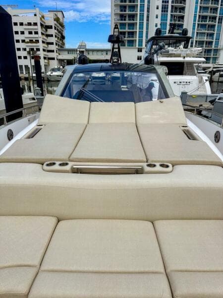 2023 Azimut Verve 47 luxury yacht with beige sunbathing deck, docked in marina.