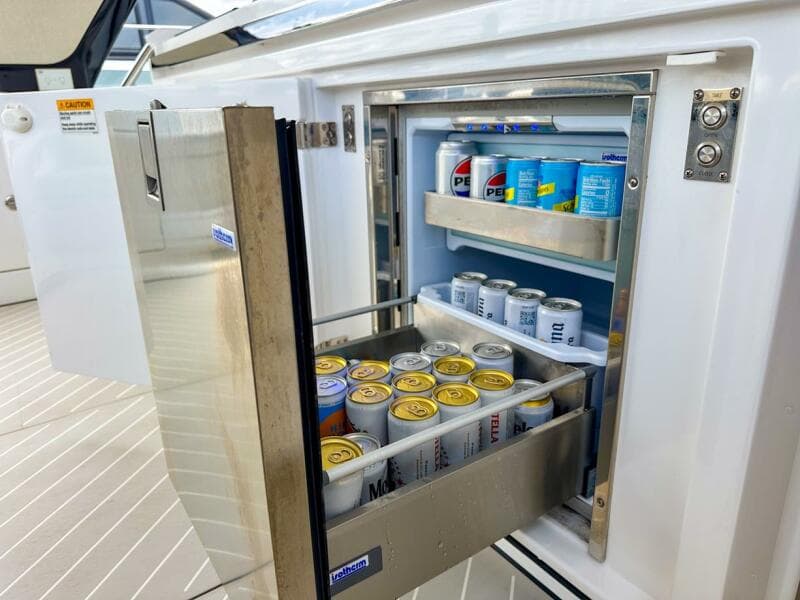 Open fridge on 2023 Azimut Verve 47 yacht, stocked with beverages.