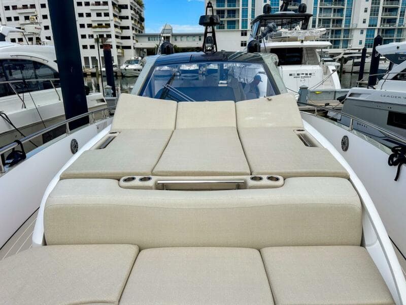 2023 Azimut Verve 47 yacht with luxurious sunbathing deck in marina setting.