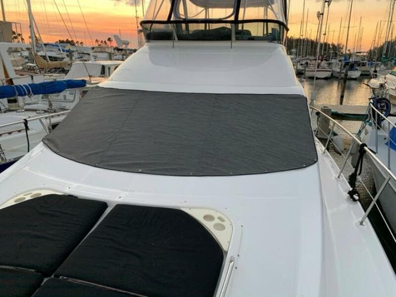 2006 Sea Ray 52 Sedan Bridge yacht docked at sunset.