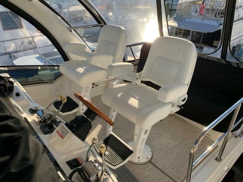 2006 Sea Ray 52 Sedan Bridge helm with dual captain's chairs and control panel.