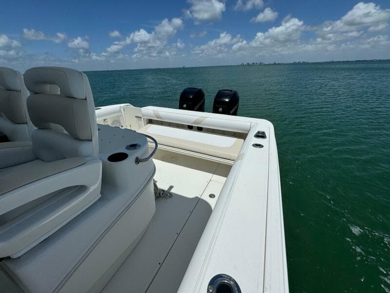 2008 Boston Whaler 320 Outrage boat on open water, featuring dual outboard motors.