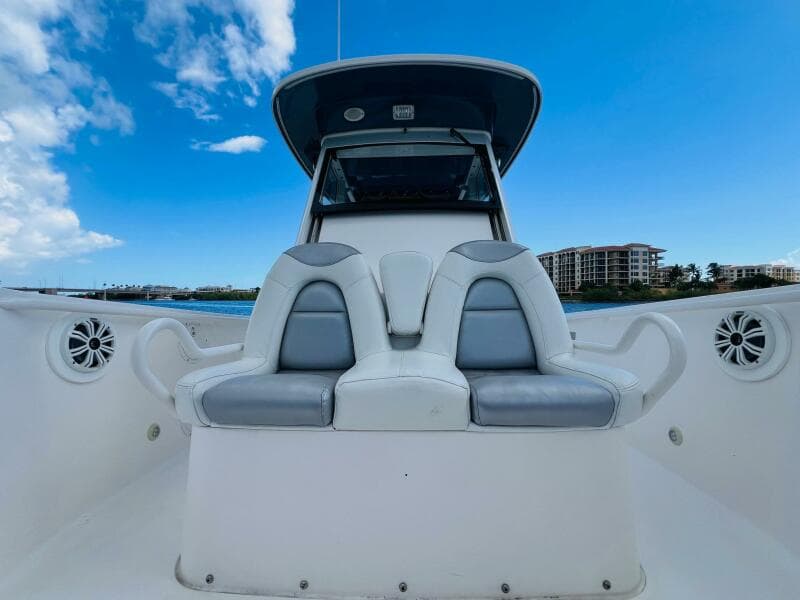 2012 Everglades 295 Center Console boat with seating, under a clear blue sky.