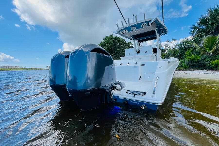 2012 Everglades 295 Center Console boat with dual engines on calm water.