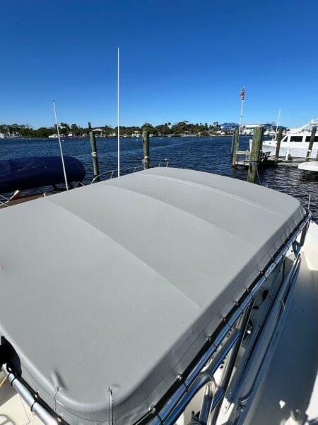 1988 Grady-White 25 SAILFISH boat with covered deck, docked by a scenic waterfront.