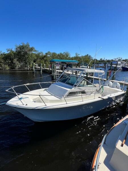 1988 Grady-White 25 SAILFISH boat docked on a sunny day.