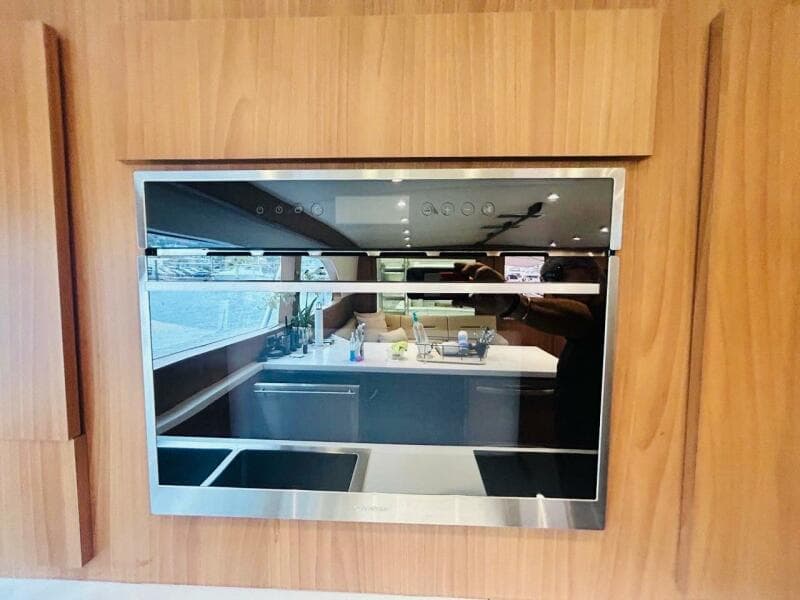 Modern kitchen interior on a 1988 Bertram 54' yacht with sleek appliances.