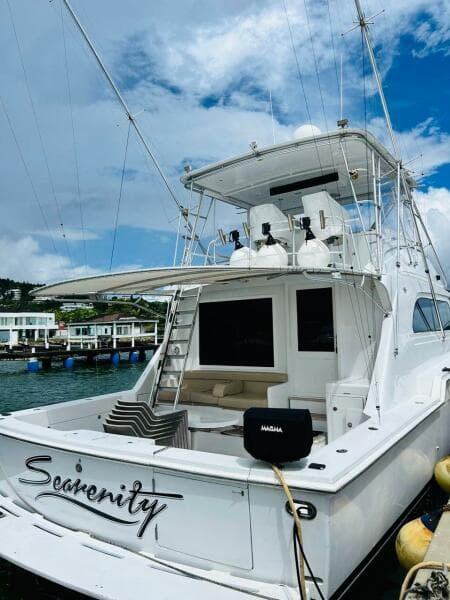 1988 Bertram 54' yacht docked, featuring spacious deck and fishing equipment.