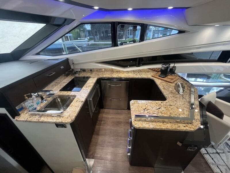 2017 Marquis 500 Sport Yacht kitchen with granite countertops and modern appliances.