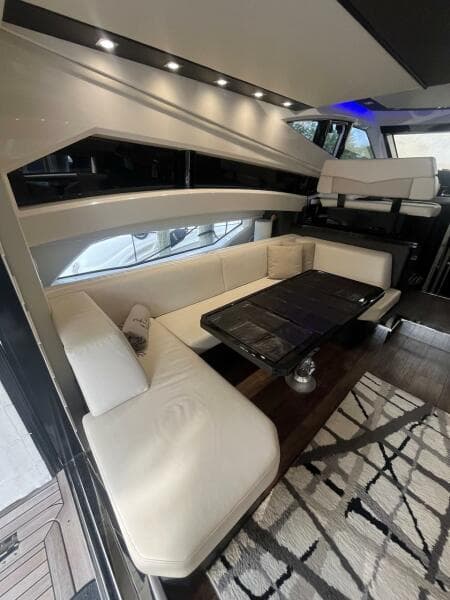 Interior of 2017 Marquis 500 Sport Yacht with white leather seating and modern decor.