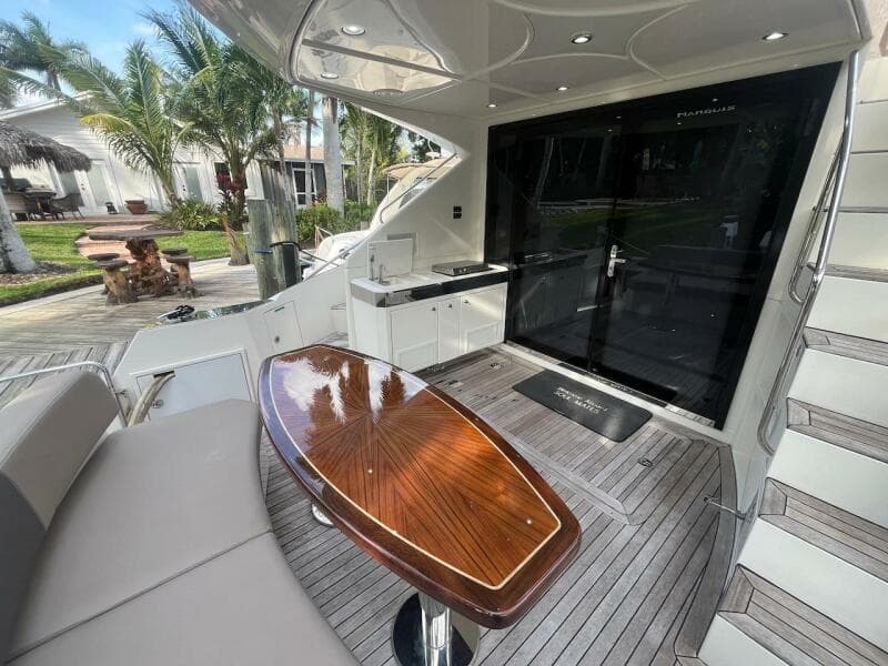2017 Marquis 500 Sport Yacht deck with seating, table, and outdoor kitchen.