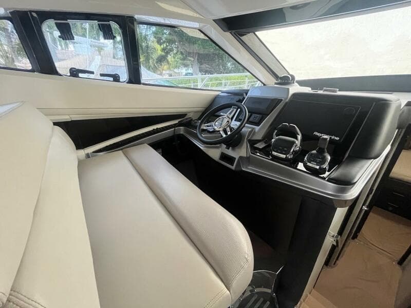 Interior helm of 2017 Marquis 500 Sport Yacht with modern controls and steering wheel.