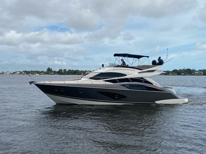 2017 Marquis 500 Sport Yacht cruising on a calm waterway.
