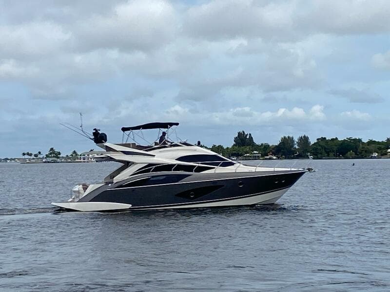 2017 Marquis 500 Sport Yacht cruising on a calm lake.