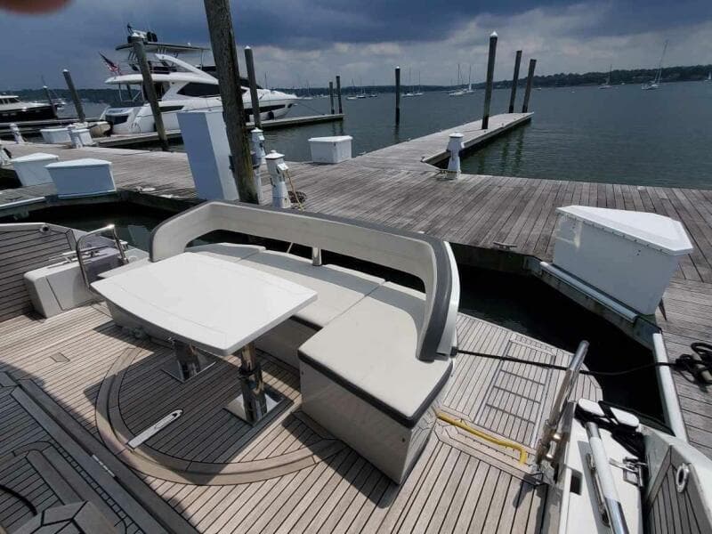 Galeon 500 Fly 2020 yacht at dock with seating and table on deck.