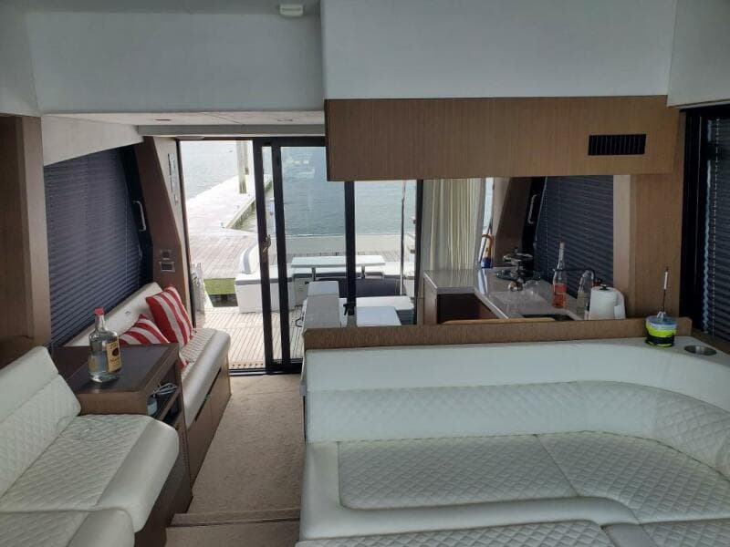 Interior of 2020 Galeon 500 Fly yacht with modern white seating and kitchenette.