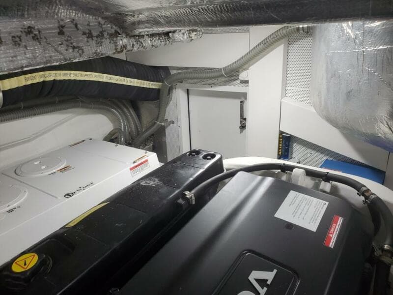 Engine room of a 2020 Galeon 500 Fly yacht with visible machinery and wiring.