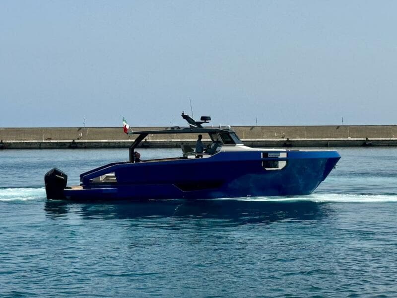 Aicon Audace 50 yacht, 2025 model, cruising in a harbor with a clear sky.