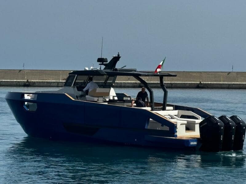 Aicon Audace 50 yacht, 2025 model, cruising in calm waters near a breakwater.