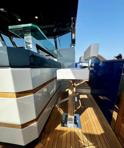 Luxury yacht Aicon Audace 50, 2025 model, featuring sleek bar seating and modern design.