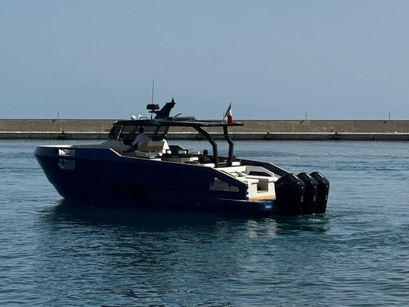 2025 Aicon Audace 50 yacht on calm water near a pier.