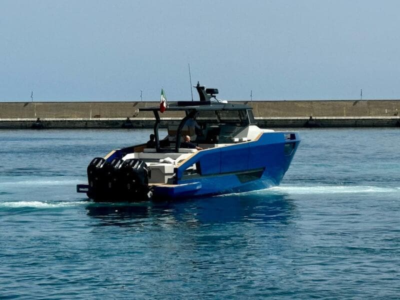 Aicon Audace 50 yacht, 2025 model, cruising in calm waters near a breakwater.