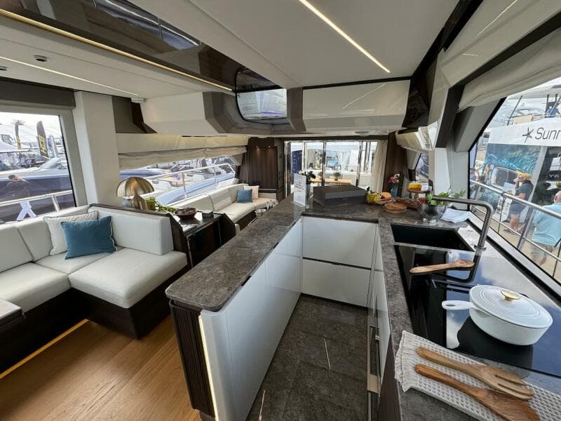 Luxurious interior of 2024 Aicon 66 Vivere yacht with modern kitchen and seating area.